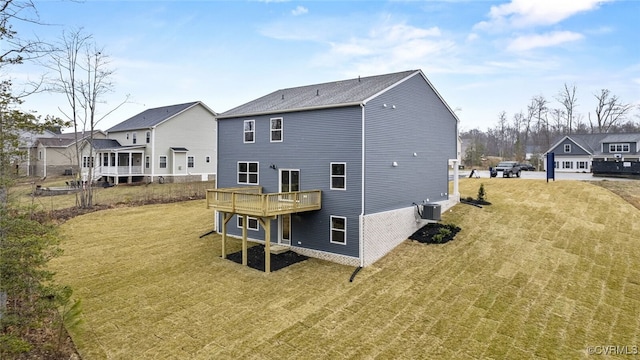 back of property with central AC unit, a lawn, and a deck