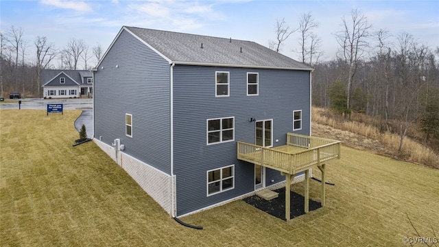 back of property with a deck and a lawn