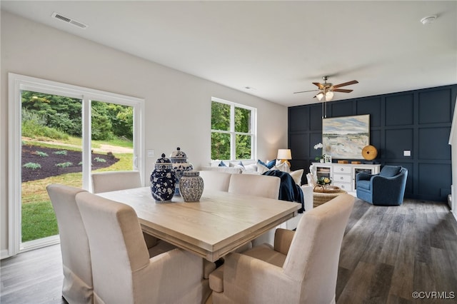 dining room featuring ceiling fan, hardwood / wood-style flooring, and a healthy amount of sunlight