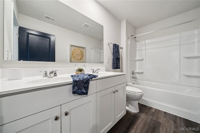 full bathroom with bathing tub / shower combination, vanity, toilet, and hardwood / wood-style flooring