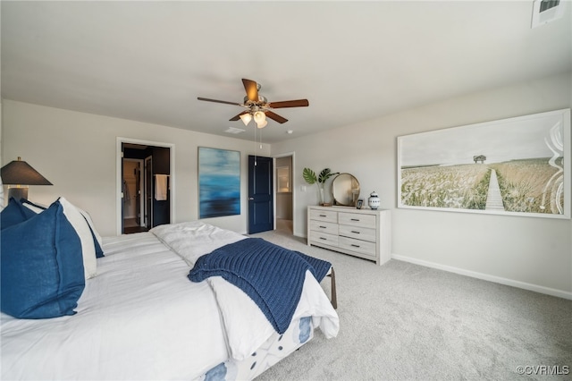 bedroom featuring ceiling fan, light colored carpet, and a spacious closet