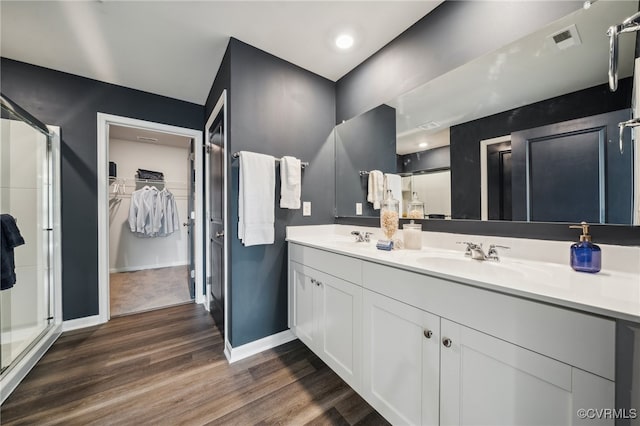 bathroom featuring vanity, hardwood / wood-style floors, and a shower with shower door