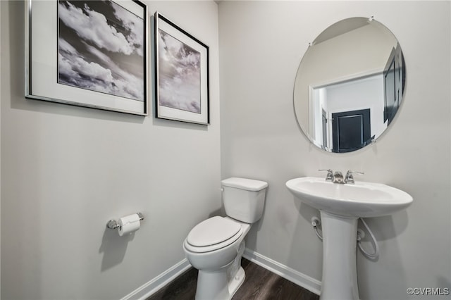 bathroom with sink, hardwood / wood-style flooring, and toilet