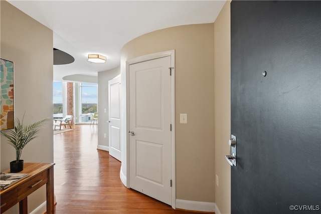 corridor with hardwood / wood-style floors