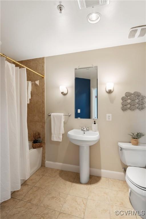 bathroom with shower / tub combo and toilet