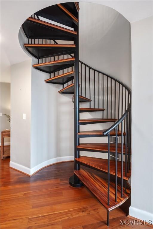 staircase featuring wood-type flooring