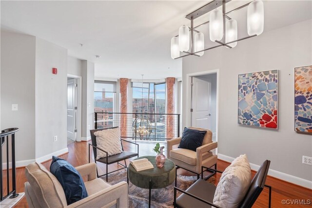 living room with wood-type flooring and a notable chandelier