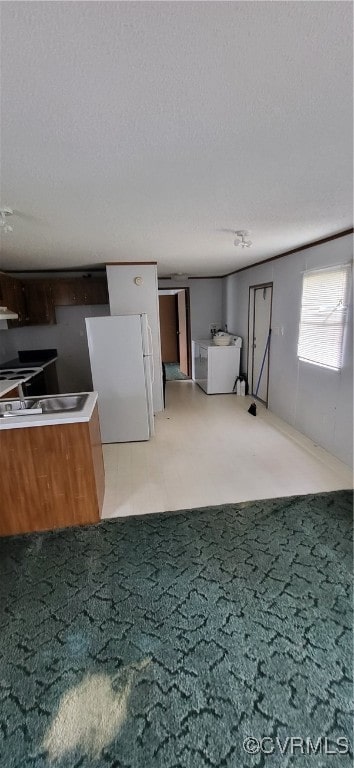 interior space with light colored carpet, a textured ceiling, and white fridge