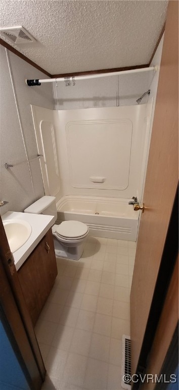 full bathroom with vanity, bathing tub / shower combination, toilet, and a textured ceiling