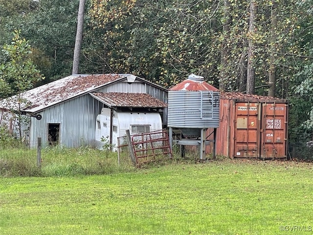 view of outbuilding featuring a lawn