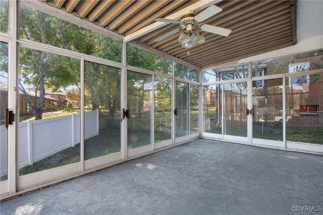 unfurnished sunroom with ceiling fan