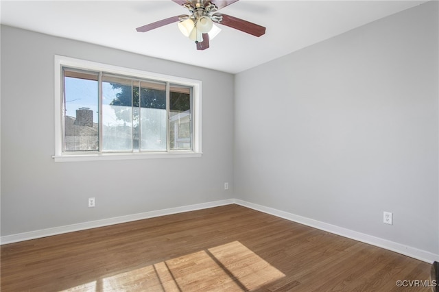 spare room featuring hardwood / wood-style floors and ceiling fan