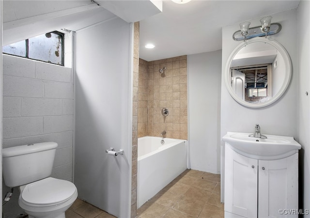 full bathroom featuring vanity, tiled shower / bath combo, tile patterned floors, and toilet