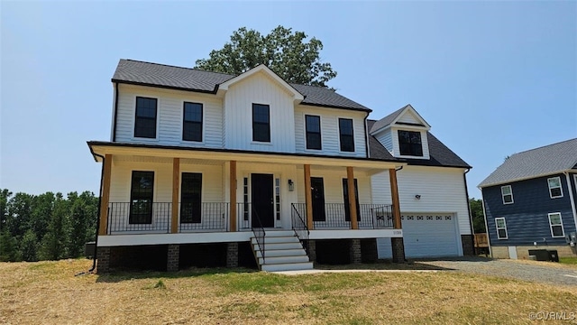 modern farmhouse style home with a porch, a garage, and a front yard