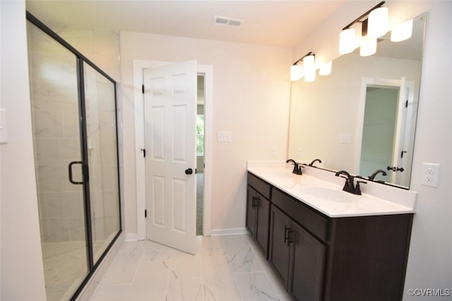 bathroom with vanity and a shower with door