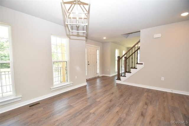 foyer featuring a notable chandelier and dark hardwood / wood-style flooring