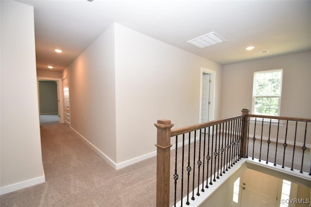 hallway with light carpet