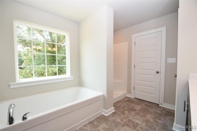 bathroom featuring shower with separate bathtub