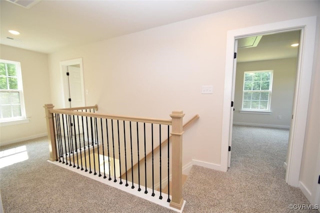 hallway featuring light carpet