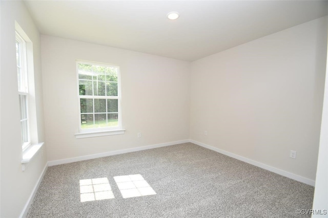 unfurnished room with light carpet