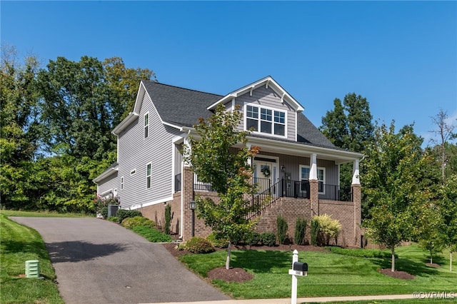 view of front of house with covered porch and a front yard