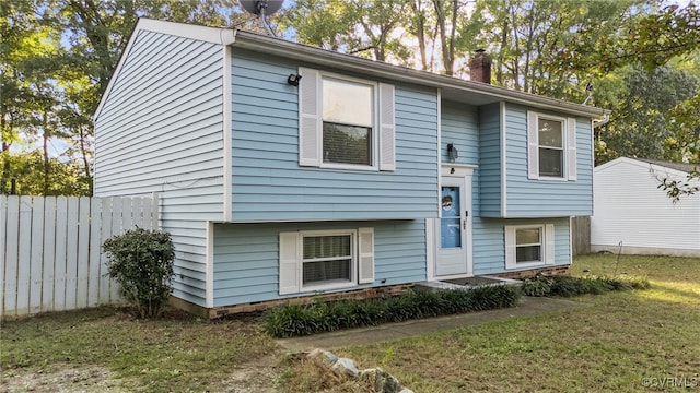 split foyer home with a front lawn