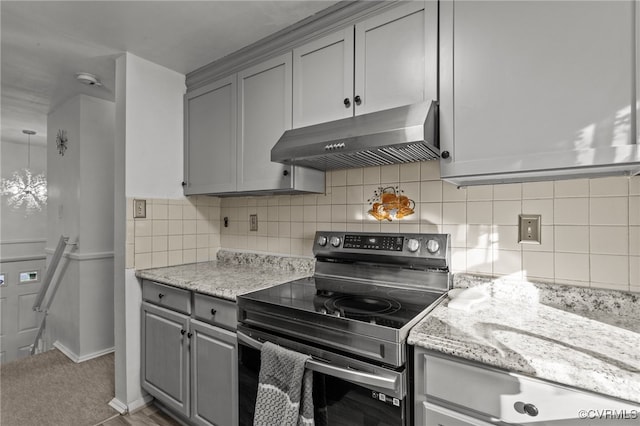 kitchen featuring backsplash, gray cabinets, stainless steel electric range oven, and light stone countertops