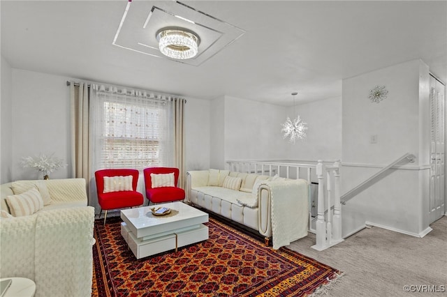 carpeted living room featuring a chandelier