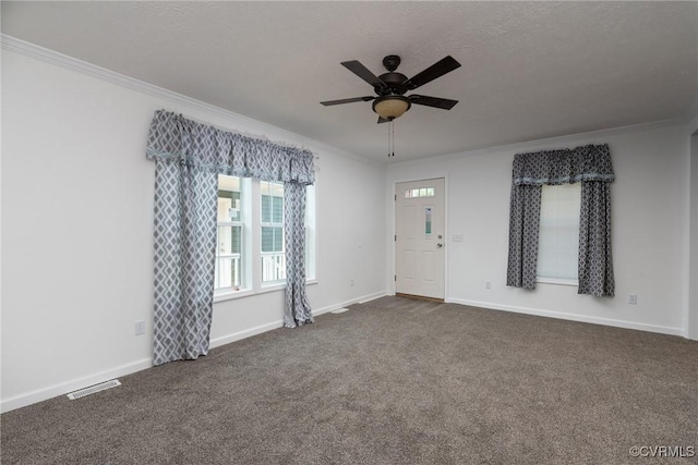 751 Jones St, Petersburg, VA 23803 - spare room with crown molding, dark carpet, and a ceiling fan