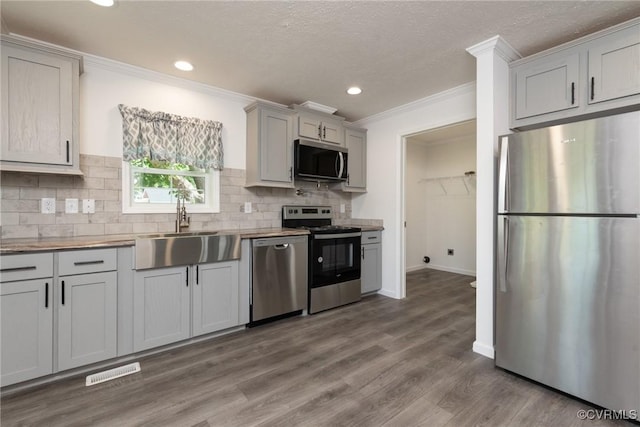751 Jones St, Petersburg, VA 23803 - kitchen with appliances with stainless steel finishes, crown molding, decorative backsplash, recessed lighting, and gray cabinets