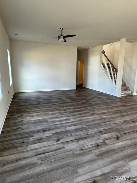 unfurnished living room with dark wood-type flooring and ceiling fan