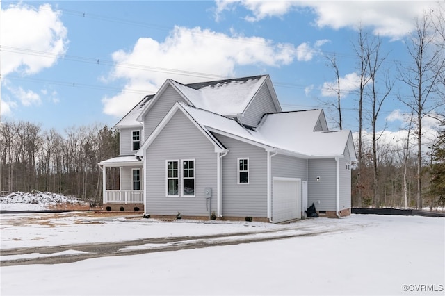 exterior space with covered porch and a garage