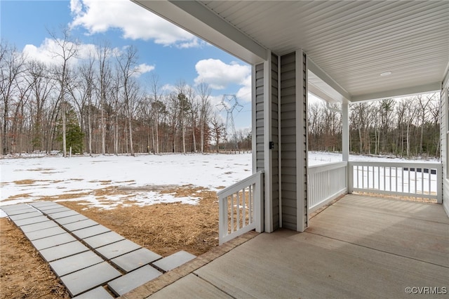 snow covered patio with a porch