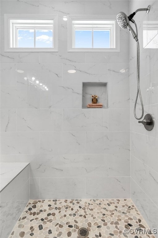 bathroom with tiled shower