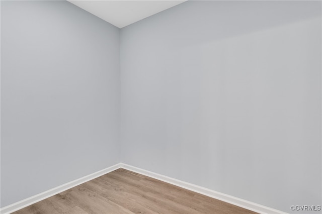 unfurnished room with wood-type flooring