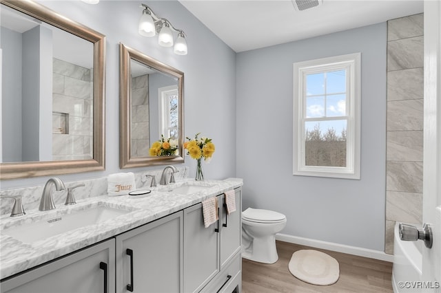 bathroom featuring wood-type flooring, vanity, and toilet