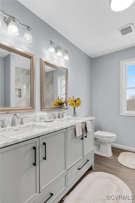 bathroom featuring wood-type flooring, vanity, and toilet