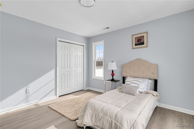 bedroom featuring wood-type flooring and a closet