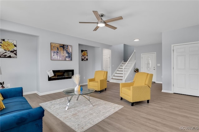 living room with ceiling fan and wood-type flooring