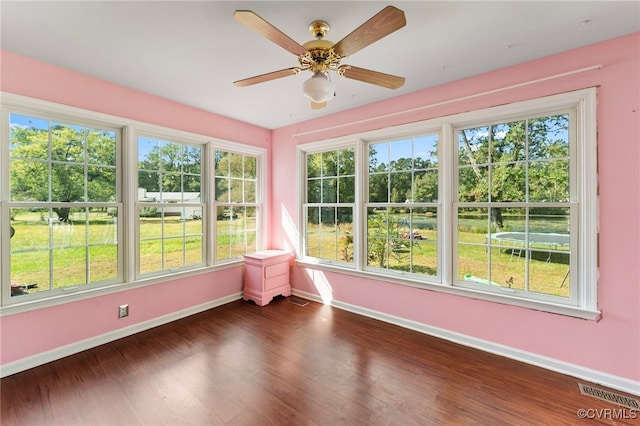 unfurnished sunroom with ceiling fan