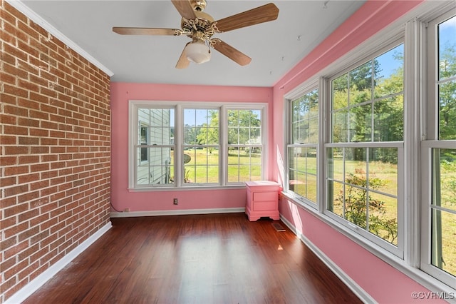 unfurnished sunroom with ceiling fan