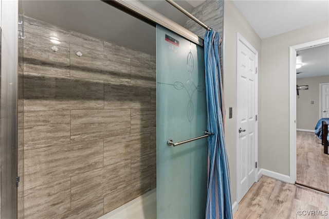 bathroom featuring wood-type flooring and curtained shower