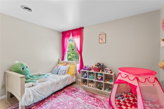 bedroom with wood-type flooring