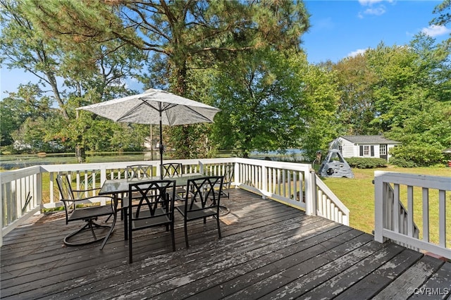 wooden terrace featuring a lawn