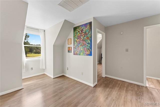 additional living space featuring light hardwood / wood-style flooring