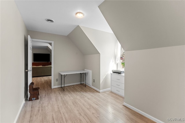 bonus room with vaulted ceiling and light hardwood / wood-style flooring