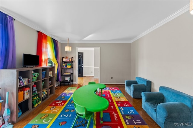 game room with crown molding and hardwood / wood-style floors