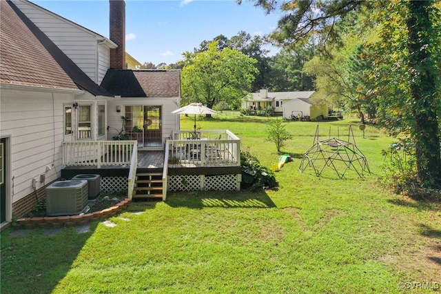 view of yard featuring a deck and central air condition unit