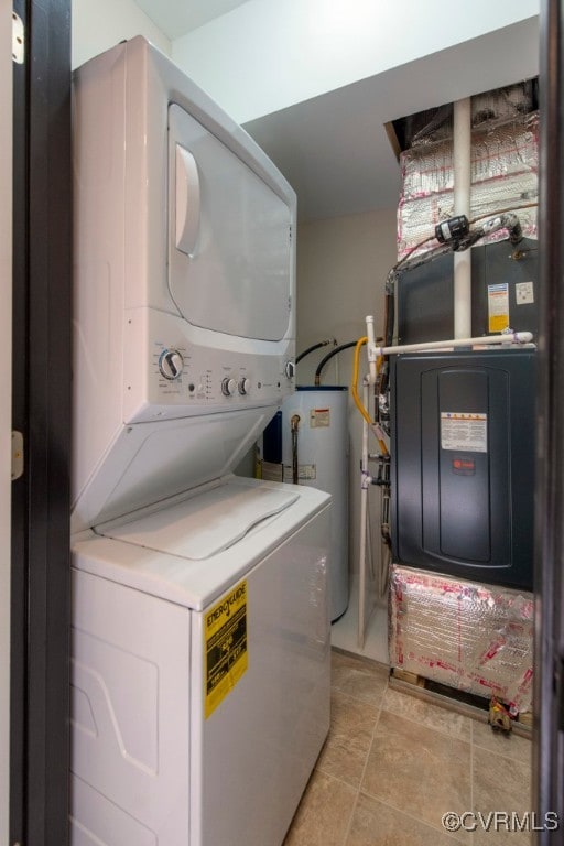 laundry room featuring stacked washing maching and dryer, water heater, and heating unit