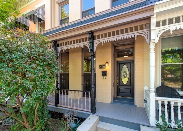 view of exterior entry featuring covered porch